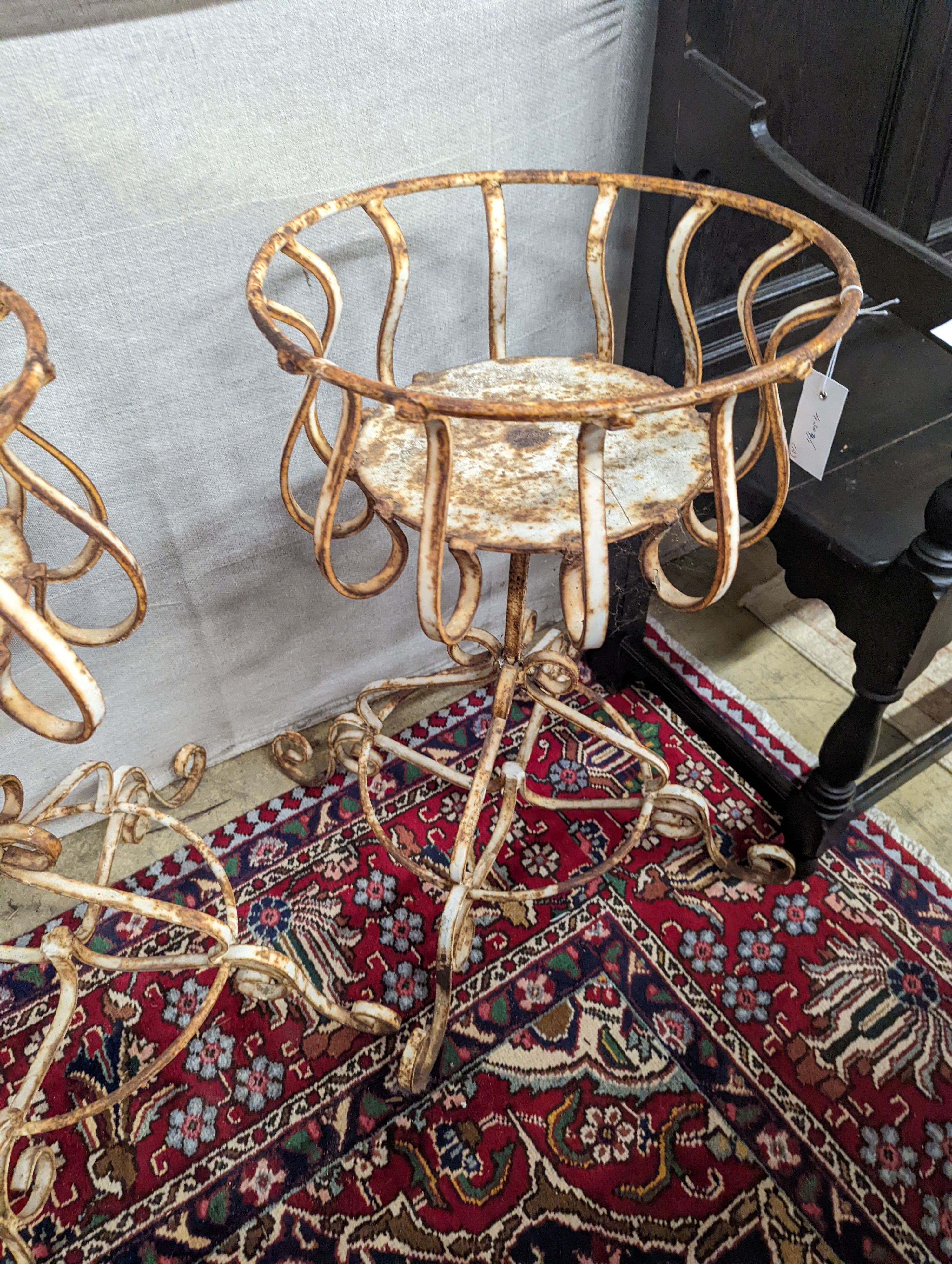 A pair of painted wrought iron garden planters, diameter 40cm, height 74cm
